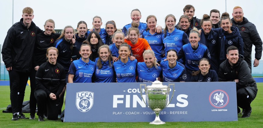 Women's football team wearing blue kit.